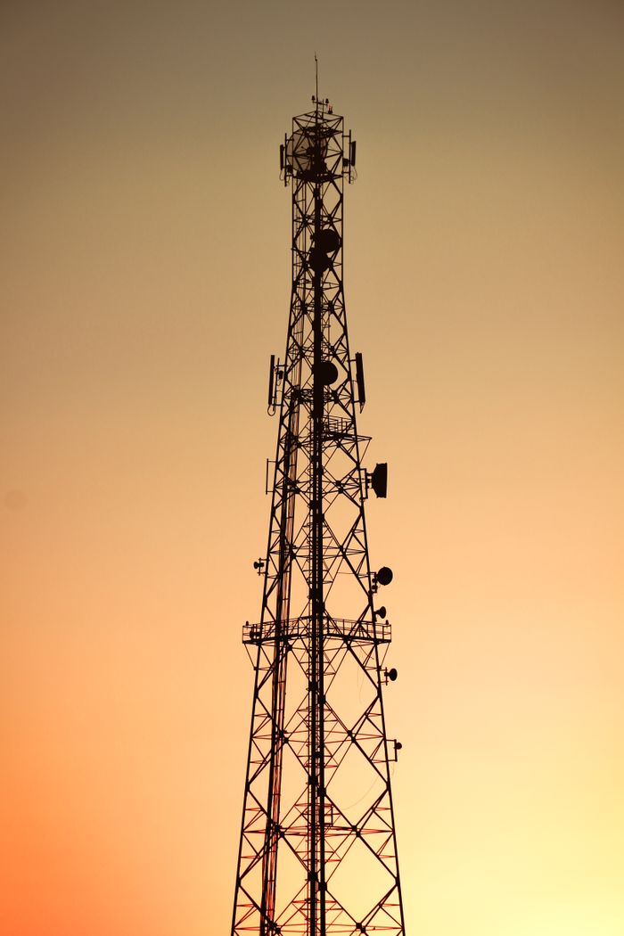 The Art of Drawing Readers In: Your attractive post title goes here Silhouette of a telecom tower against an orange sky during sunset in Algeria.