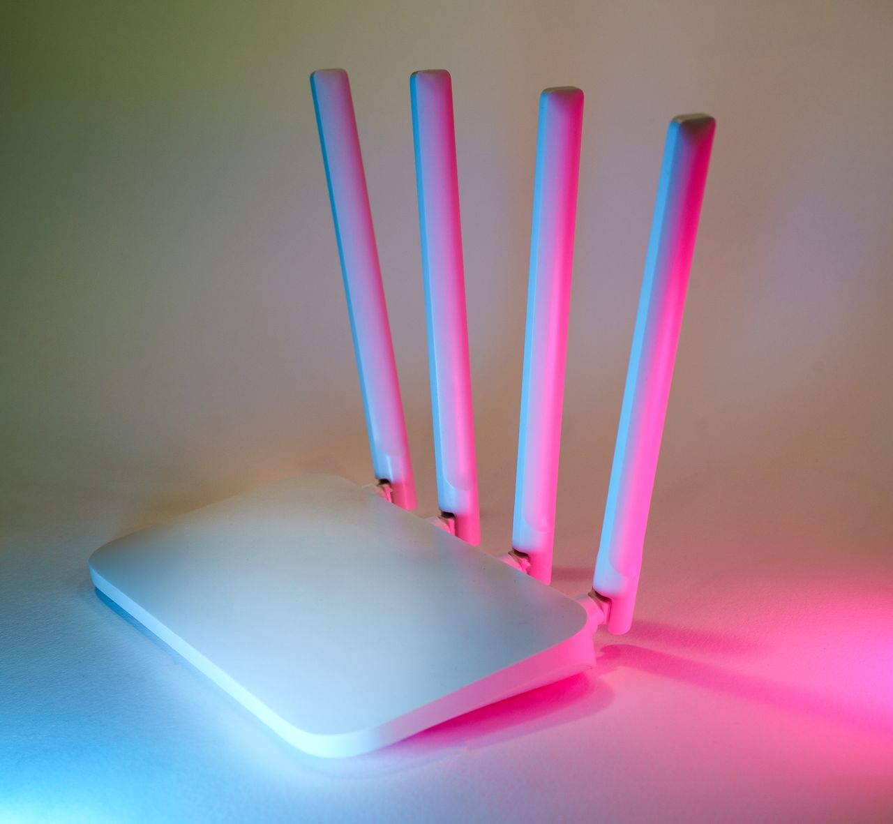 services-02 A sleek wireless router enhanced by vibrant neon lights, showcasing cutting-edge technology.