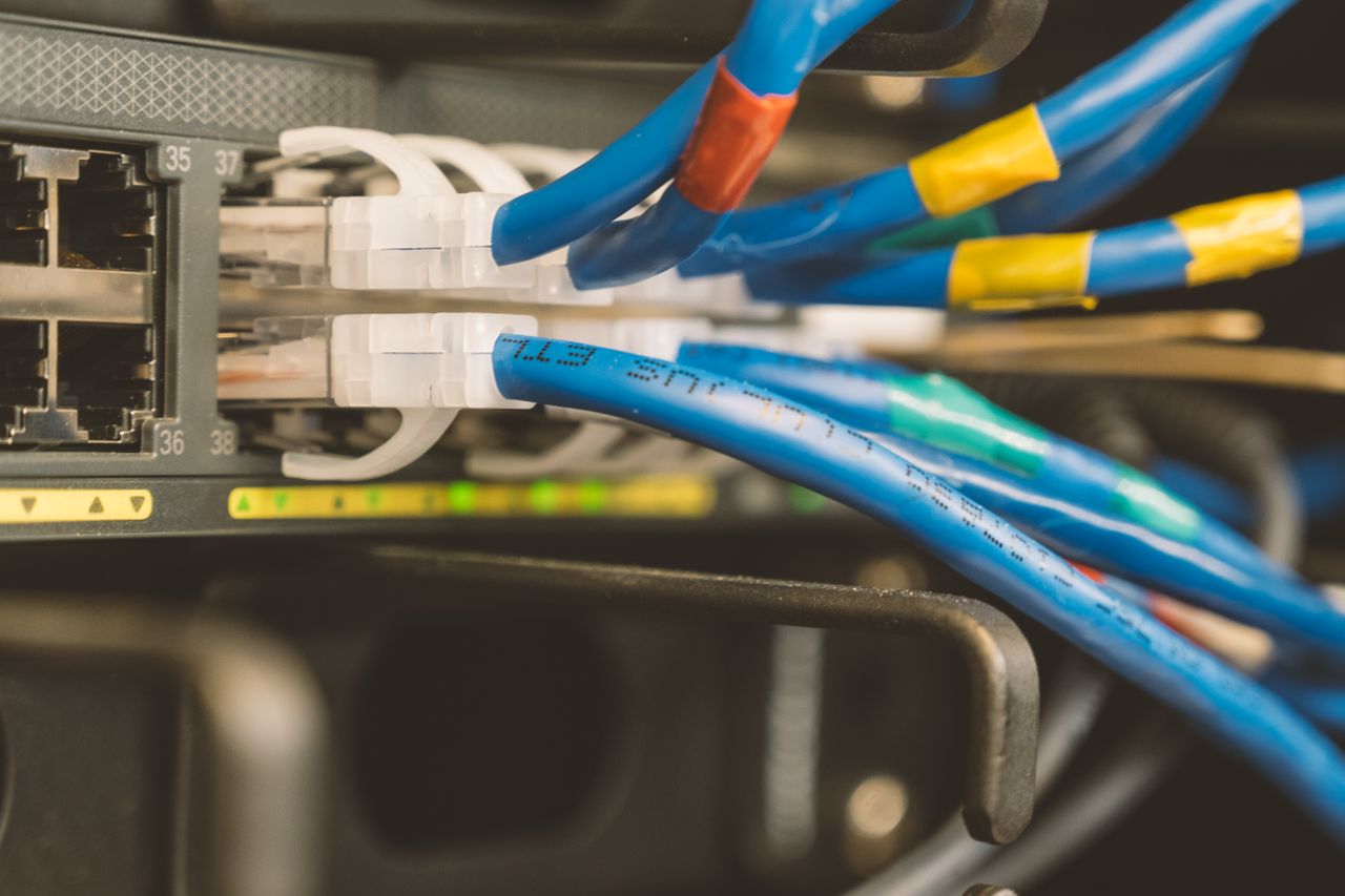 services-03 Network switch and blue ethernet cable with white tips connected to system for maintenance