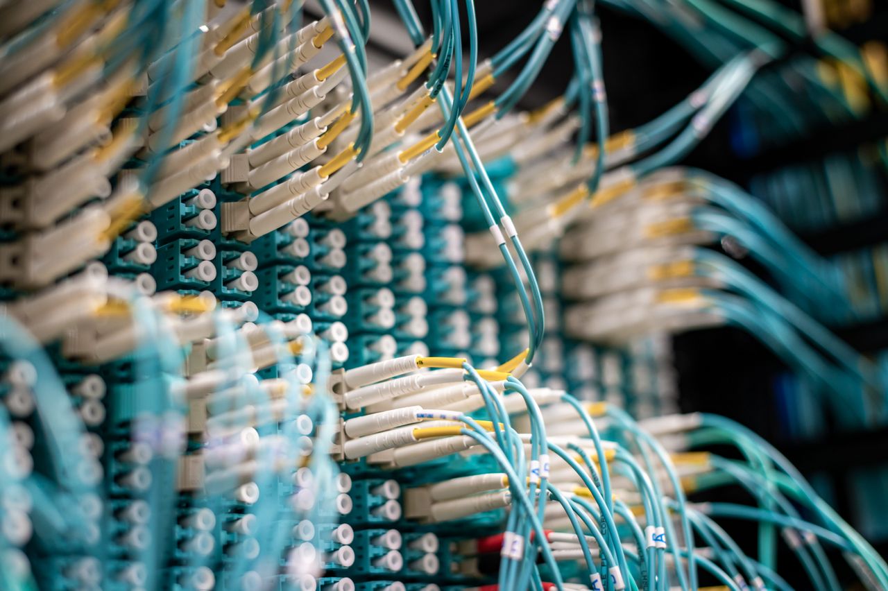 services-01 From below of fiber optic switch with sockets and connected rubber cables on blurred background